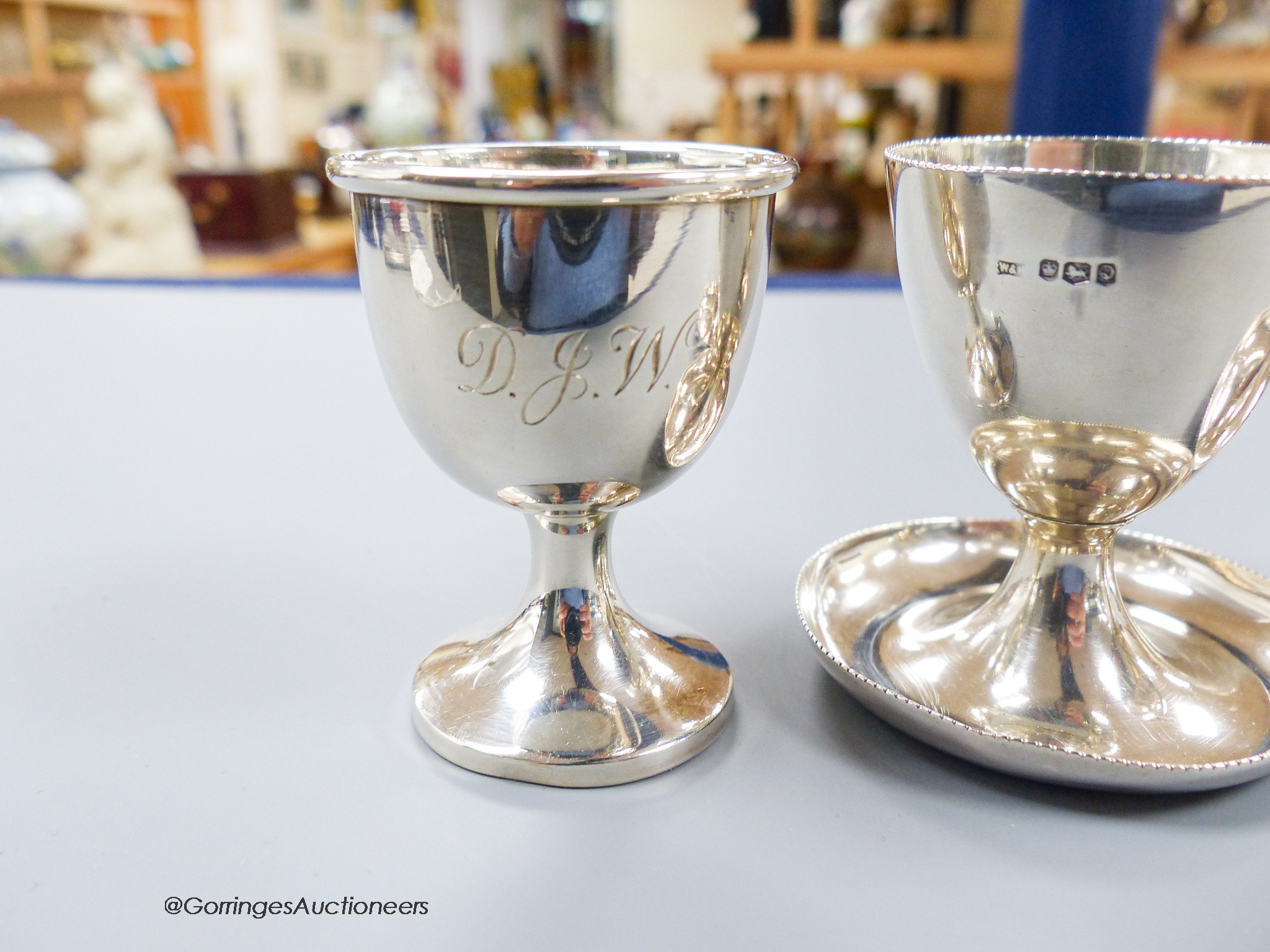 A pair of 1950's silver egg cups, Walker & Hall, Sheffield, 1957/8, 55mm and one other silver egg cup, 131 grams.